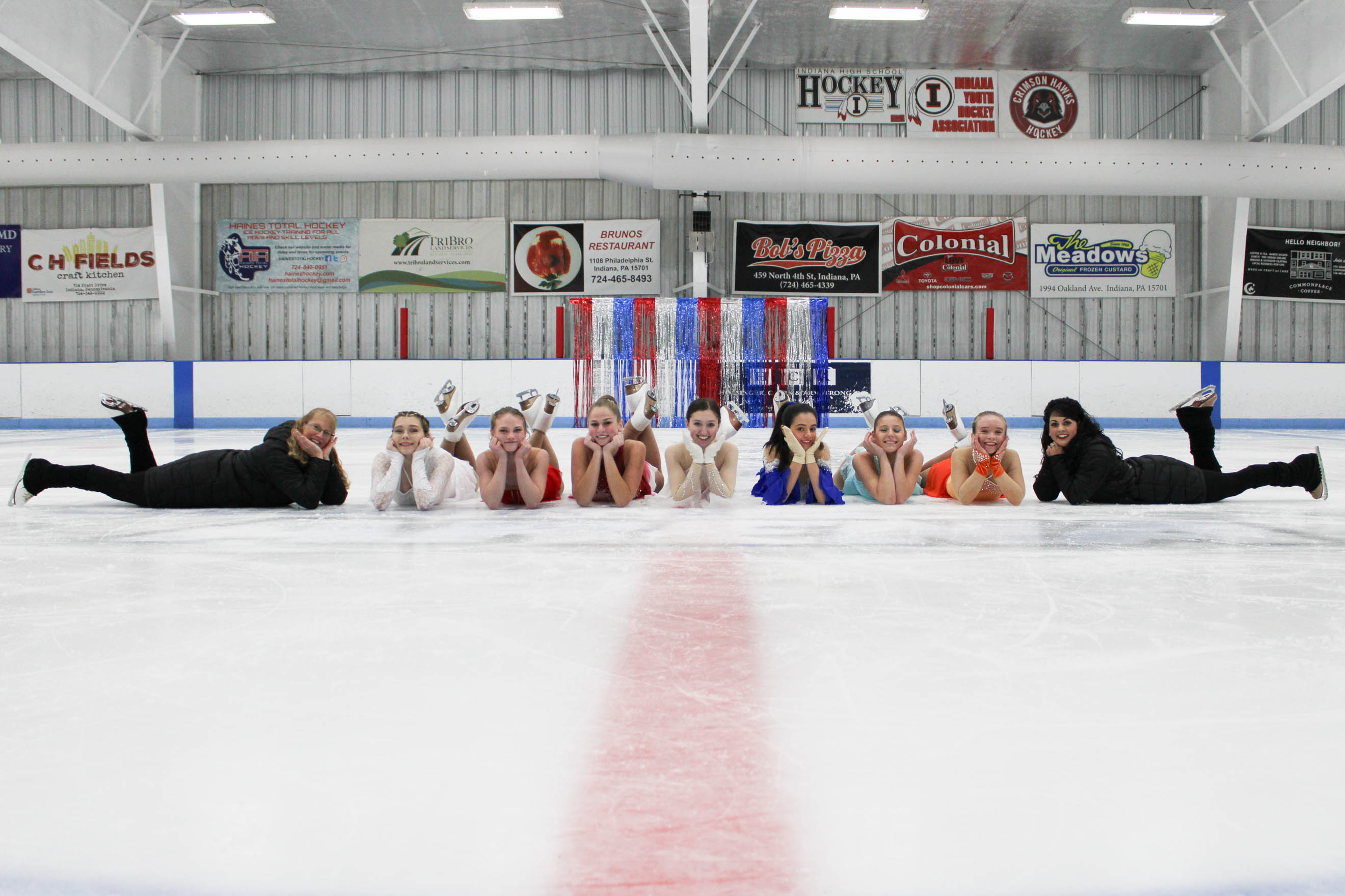 girls + coaches lay on ice